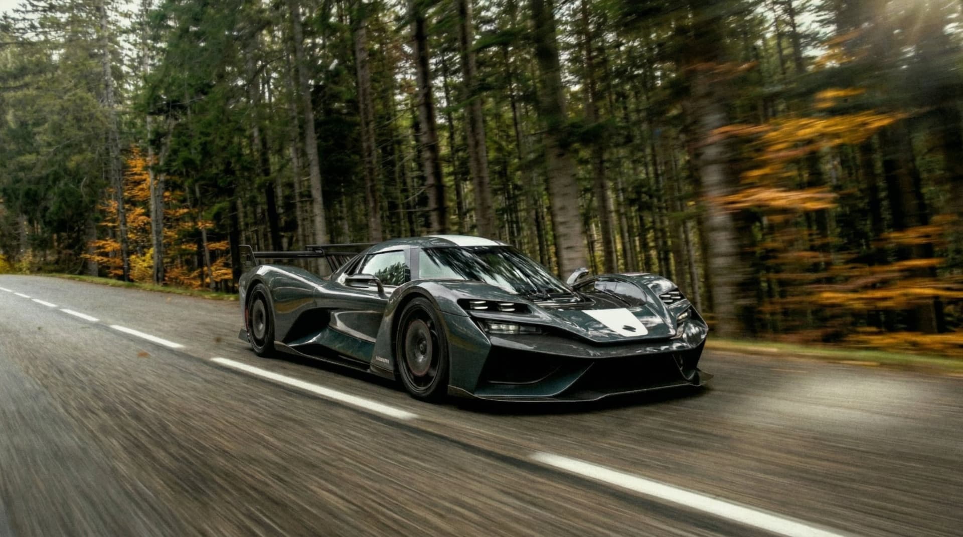 LM1 racing through an autumn forest road